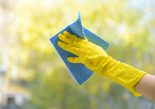 Cleaner in protective gear preparing a tenancy cleaning task